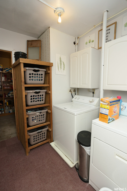 Laundry room featuring washer and dryer and dark carpet