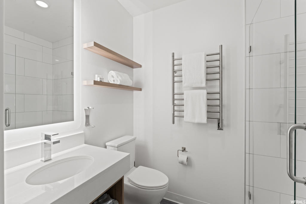Bathroom featuring vanity, mirror, and radiator heating unit