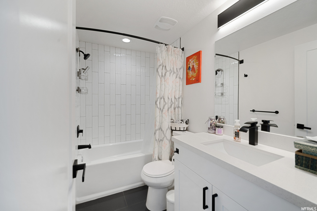 Full bathroom featuring large vanity, shower / bathtub combination with curtain, mirror, and light tile floors