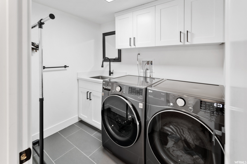 Laundry room featuring tile flooring and washing machine and clothes dryer