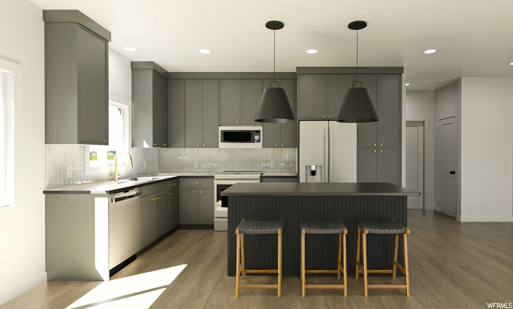 Kitchen with white appliances, dark hardwood / wood-style floors, a kitchen bar, tasteful backsplash, and gray cabinets