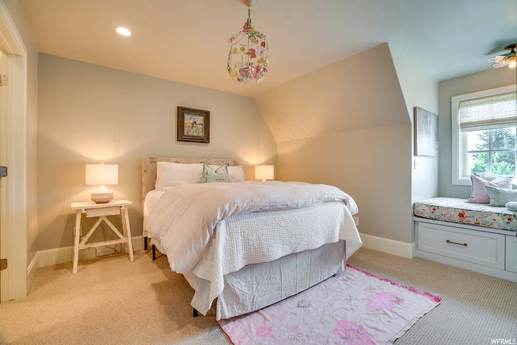 Bedroom featuring vaulted ceiling and light carpet