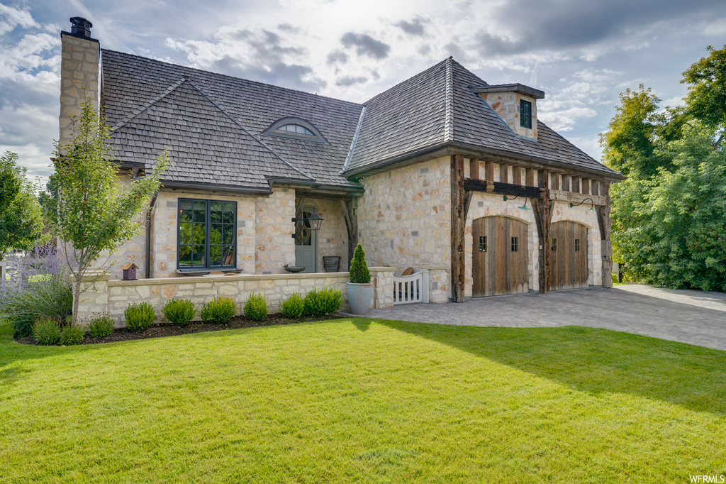 French country home featuring a front lawn