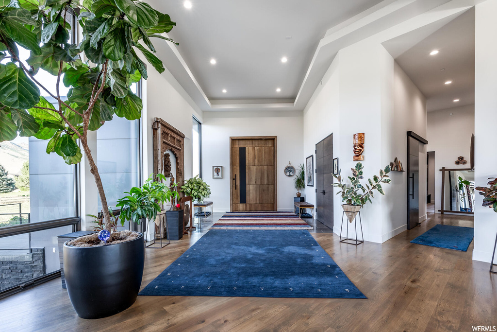 Wood floored entryway with a high ceiling