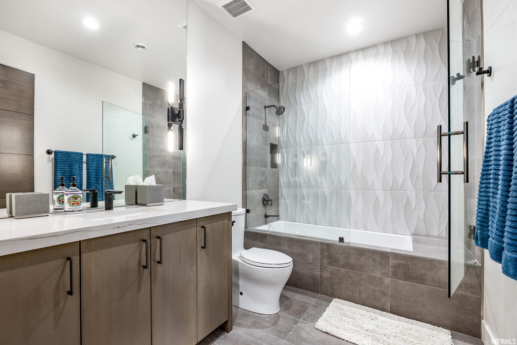Full bathroom featuring vanity, combined bath / shower with glass door, mirror, and light tile floors