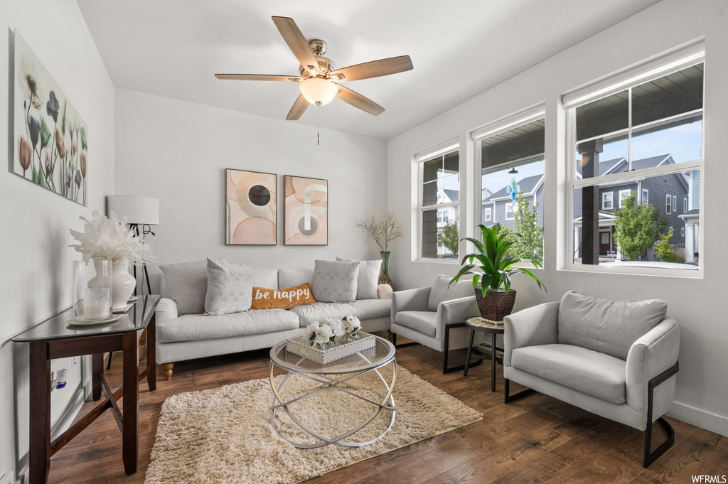 Living room featuring hardwood floors and ceiling fan