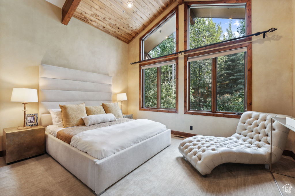 Bedroom featuring multiple windows, beam ceiling, high vaulted ceiling, and wood ceiling