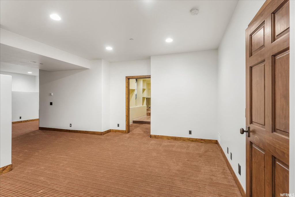 Spare room featuring light carpet