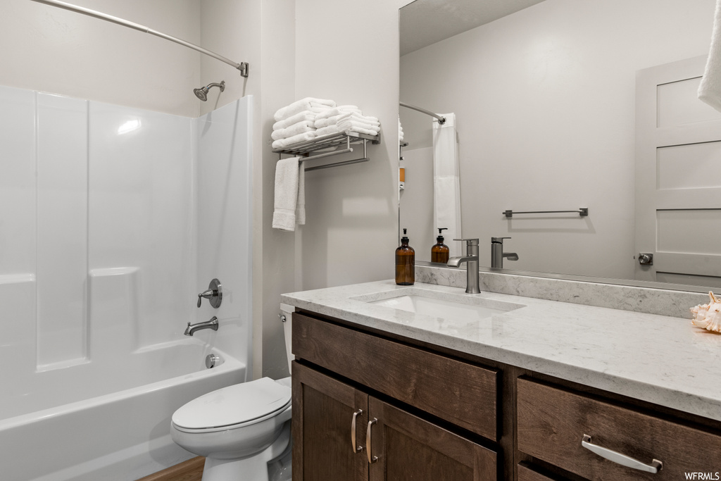 Full bathroom featuring shower / bath combo with shower curtain, vanity with extensive cabinet space, and mirror