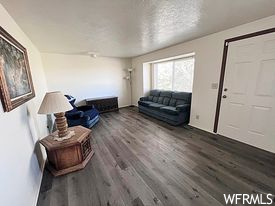 Living room featuring dark hardwood floors