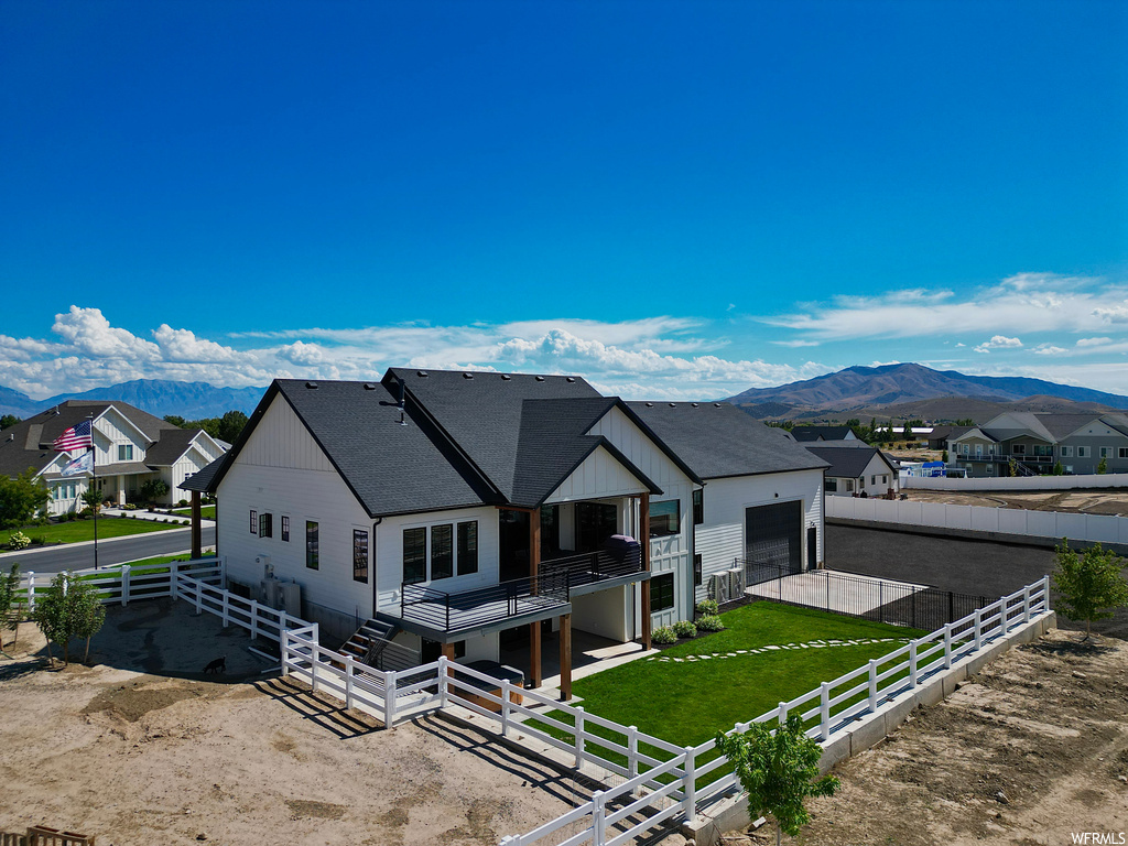 View of front of house with a front yard and a mountain view