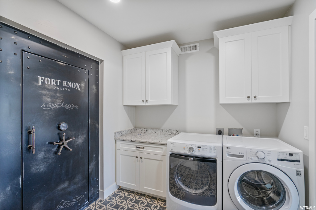 Laundry area featuring tile flooring and washer and dryer