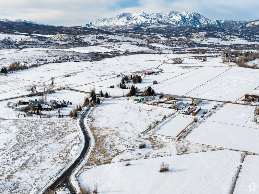 Snowy aerial view with a rural view and a mountain view