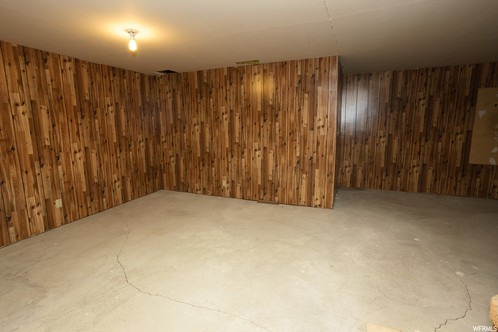 Basement featuring wood walls