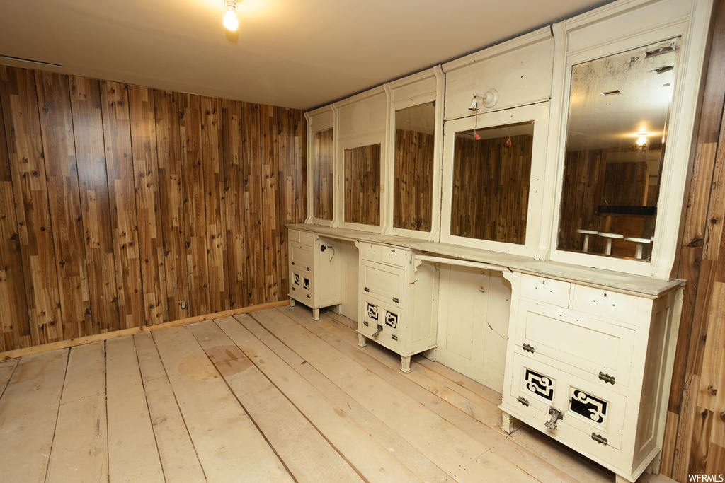 Bathroom with wooden walls and wood-type flooring