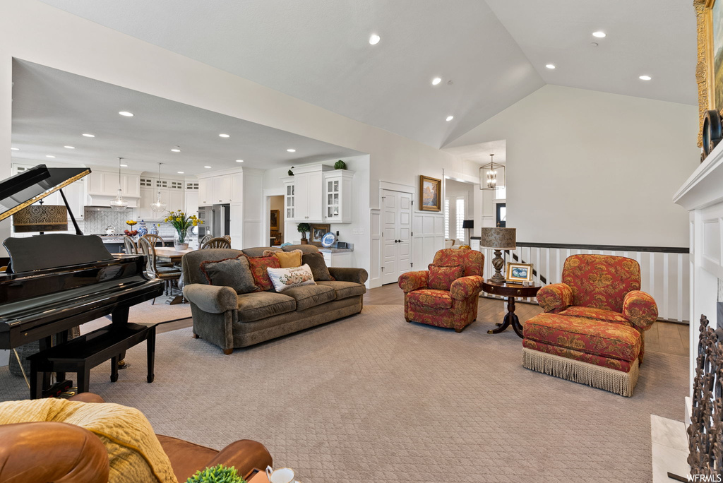 Living room featuring a high ceiling, light carpet, and vaulted ceiling