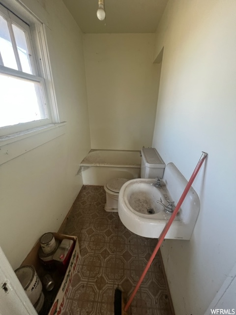 Bathroom featuring washtub / shower combination and tile floors