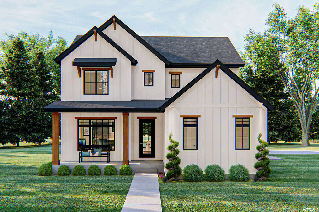 Modern farmhouse style home featuring a front yard