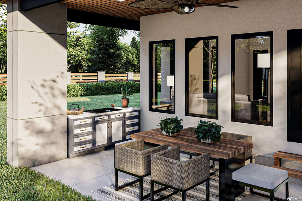 View of patio featuring an outdoor kitchen and ceiling fan