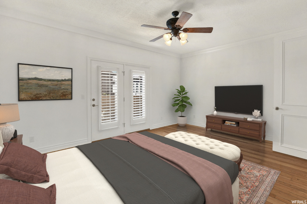 Bedroom with access to outside, crown molding, hardwood floors, and ceiling fan