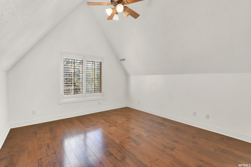Bonus room featuring wood-type flooring and lofted ceiling