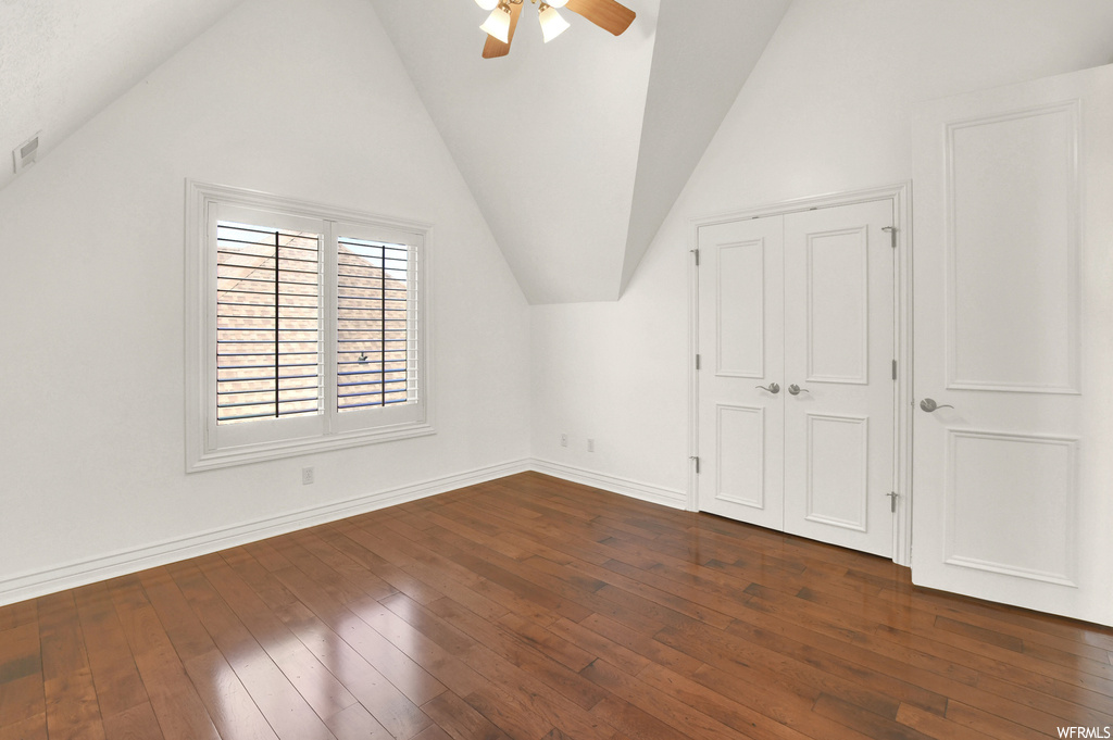 Wood floored spare room with lofted ceiling