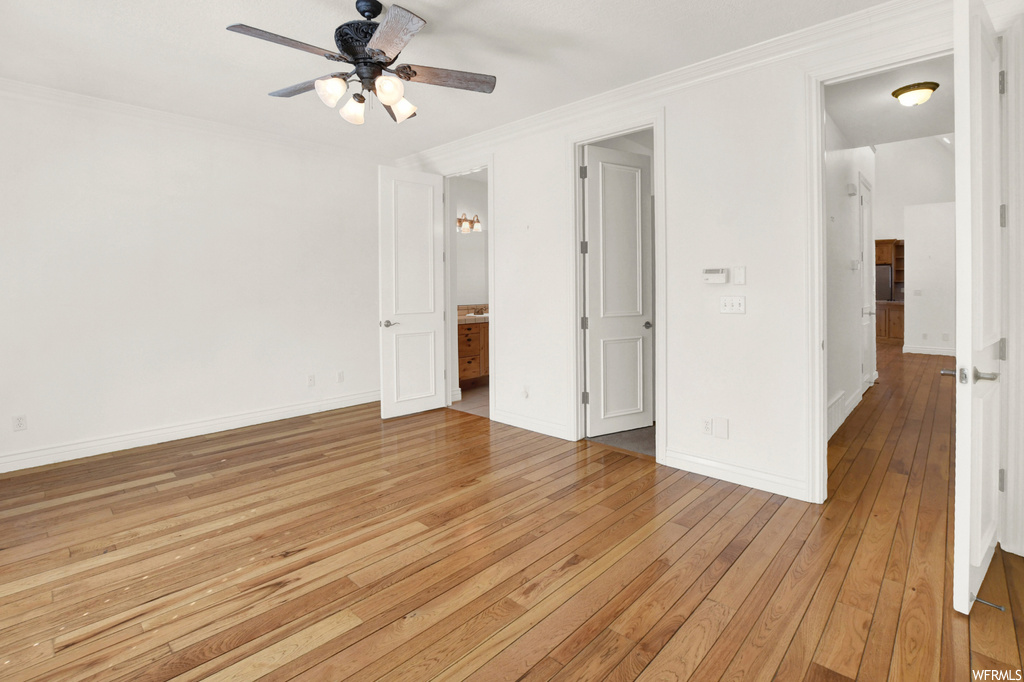 Bedroom with crown molding, light hardwood floors, and ceiling fan
