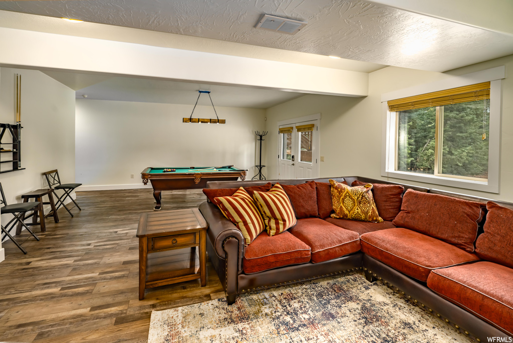 Game room featuring a textured ceiling and hardwood flooring
