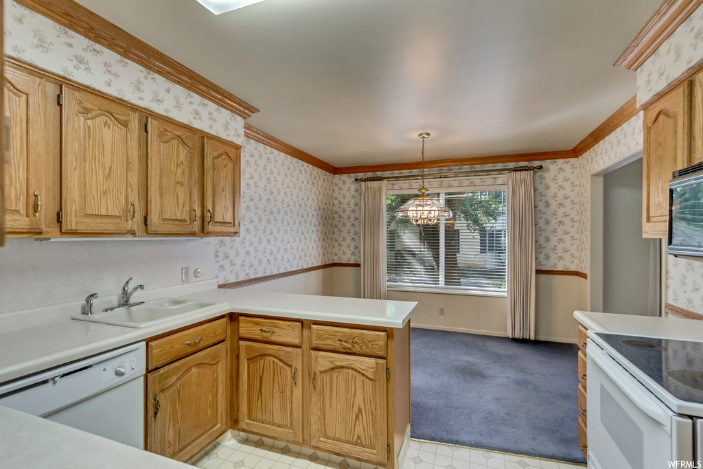 Kitchen featuring carpet, crown molding, light countertops, and white appliances