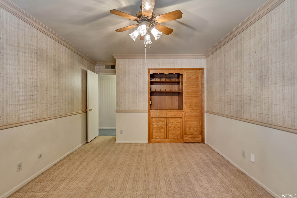 Bedroom with light carpet and crown molding