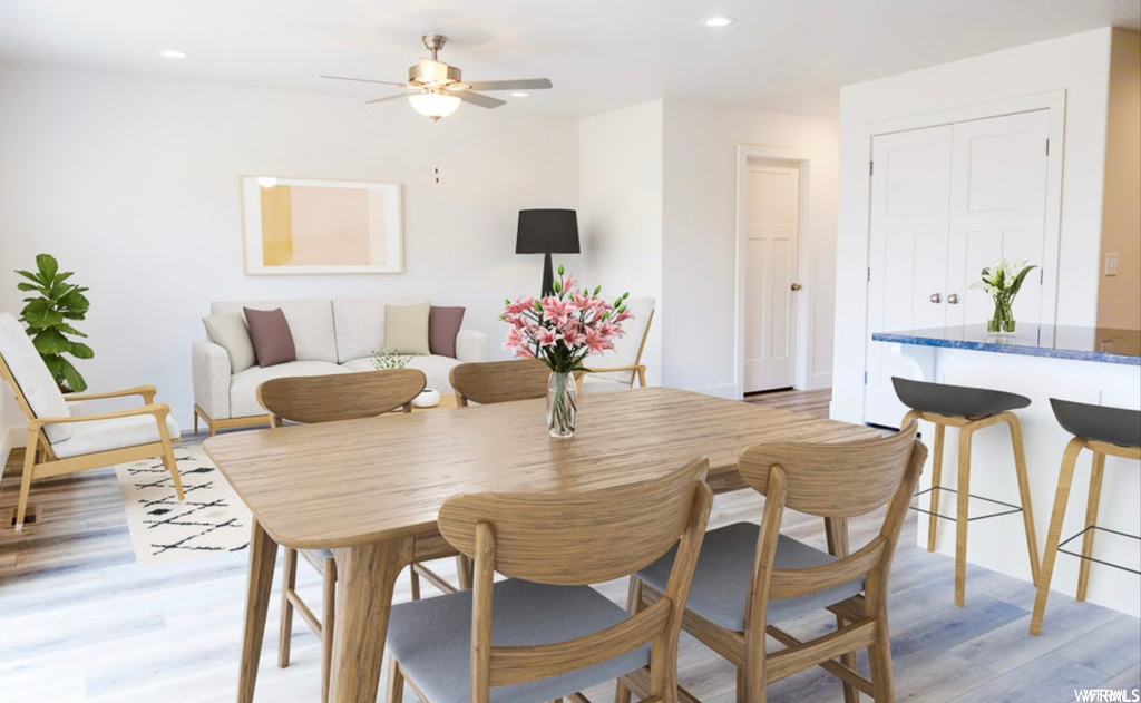 Wood floored dining room featuring ceiling fan