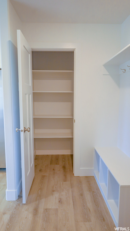 Spacious closet with light hardwood floors