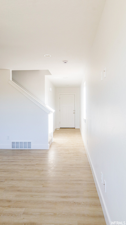 Hallway featuring light hardwood flooring