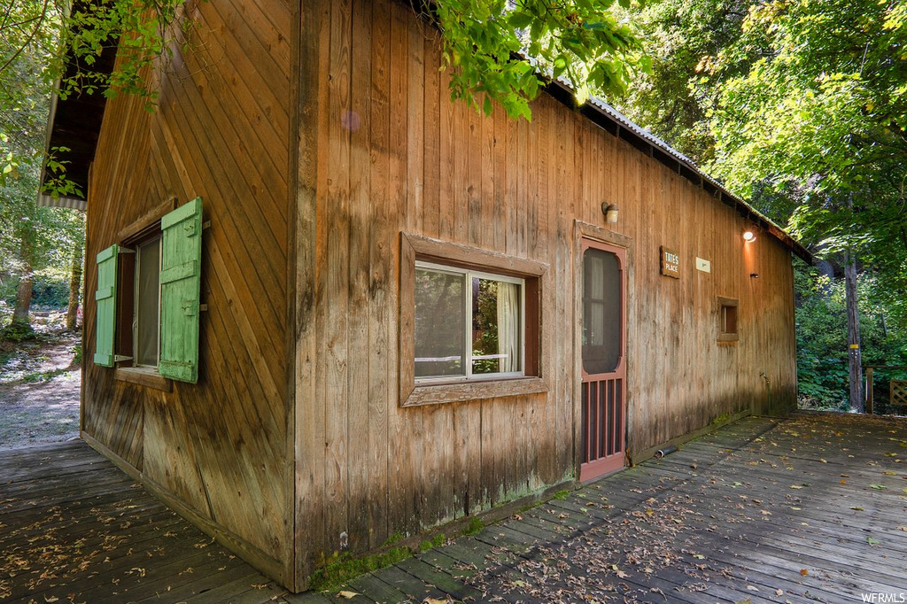 View of home\'s exterior featuring a wooden deck