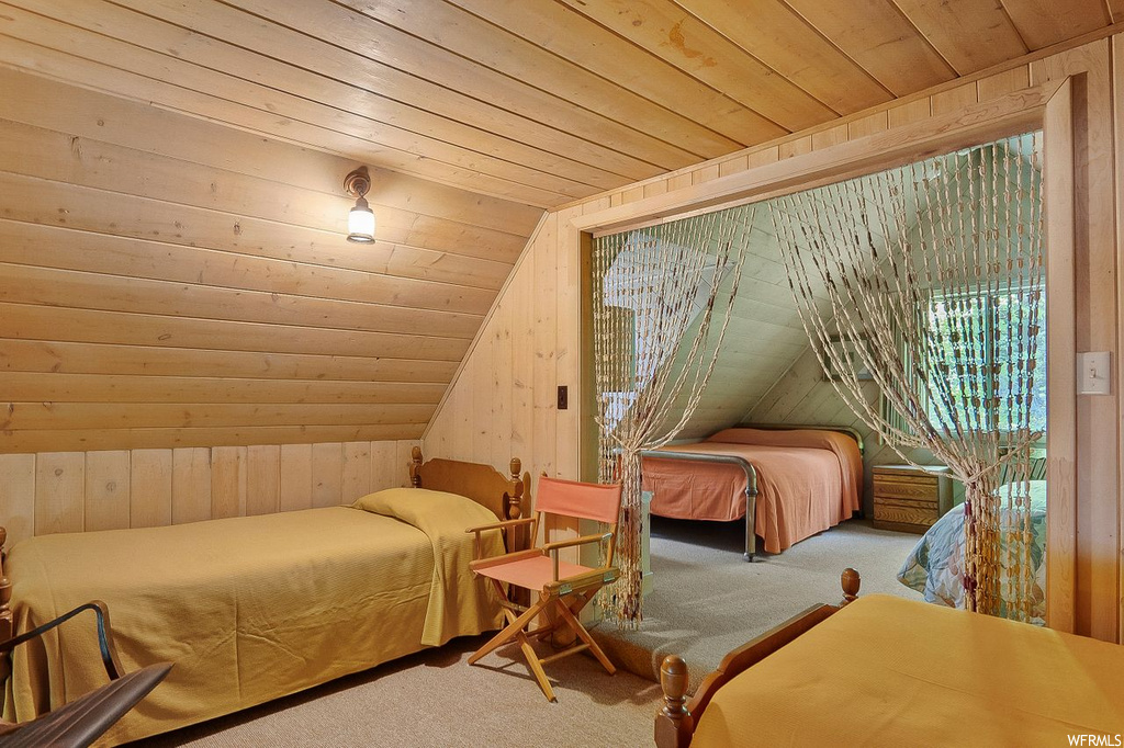 Carpeted bedroom with wood ceiling and vaulted ceiling