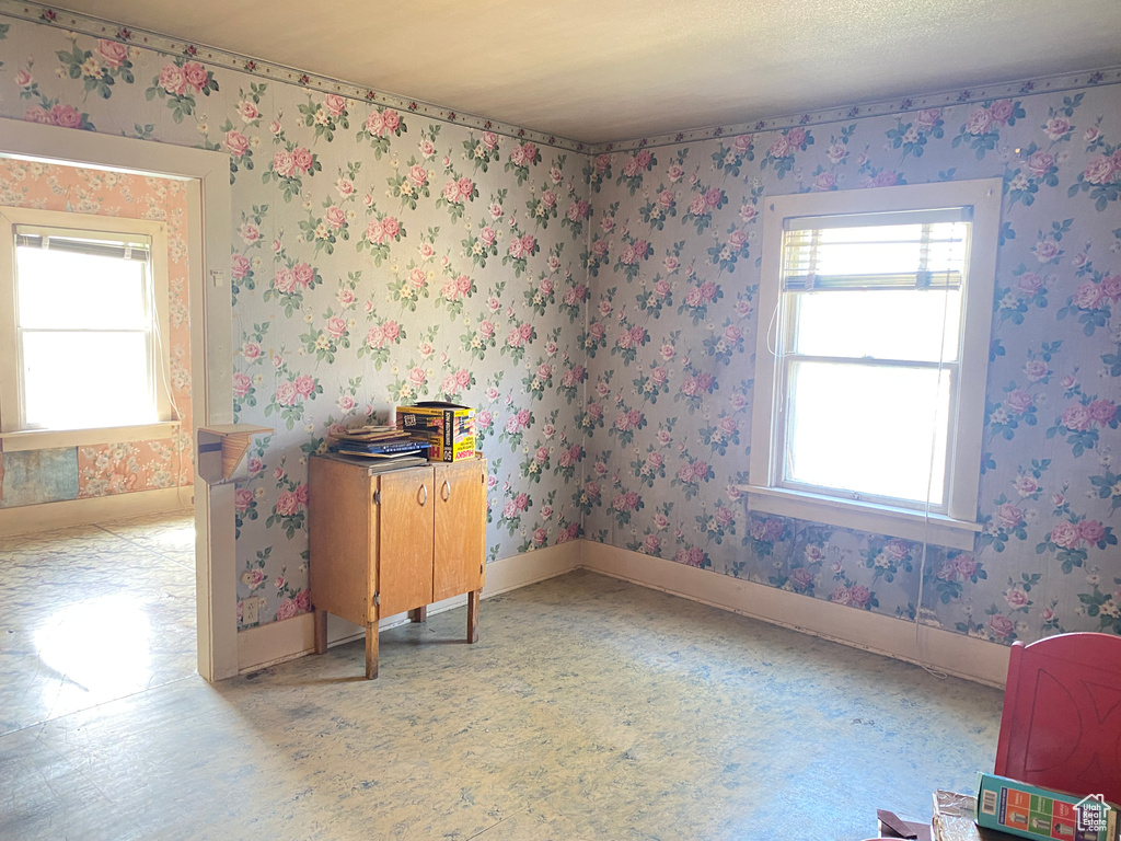 Unfurnished room featuring plenty of natural light