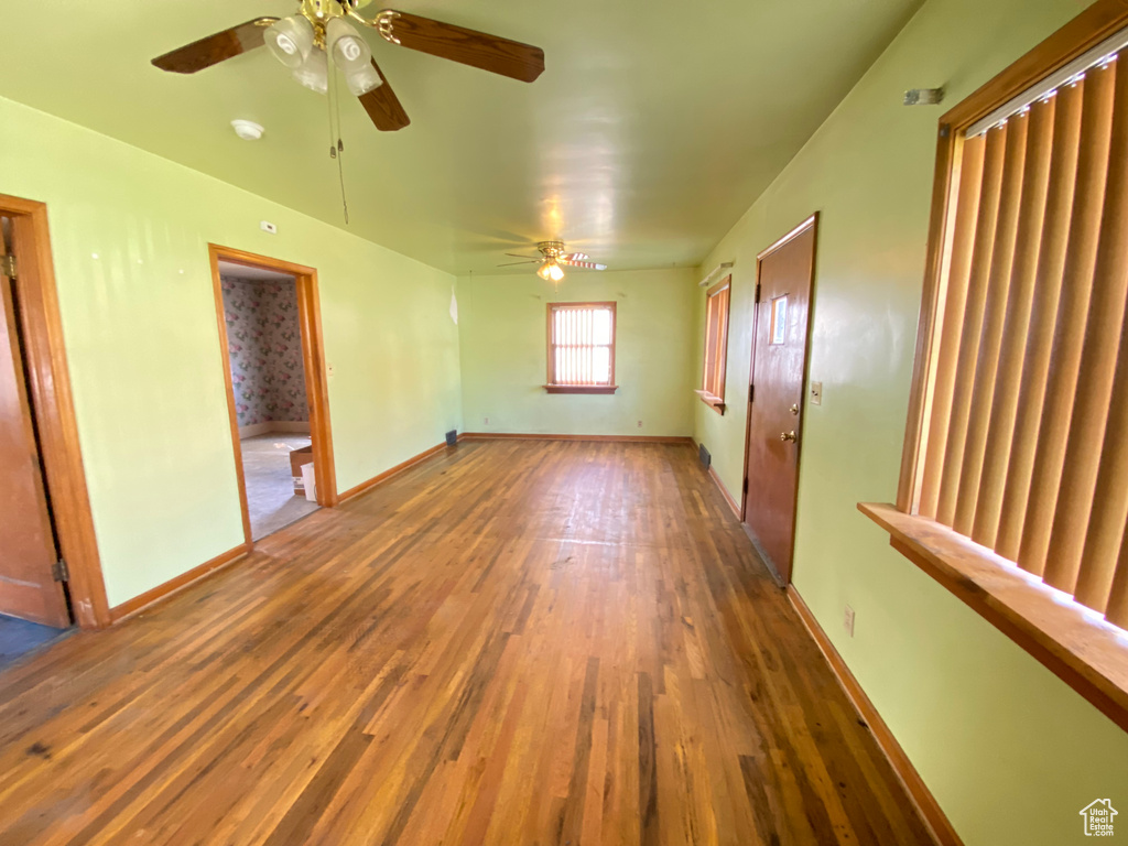 Unfurnished room with hardwood / wood-style floors and ceiling fan