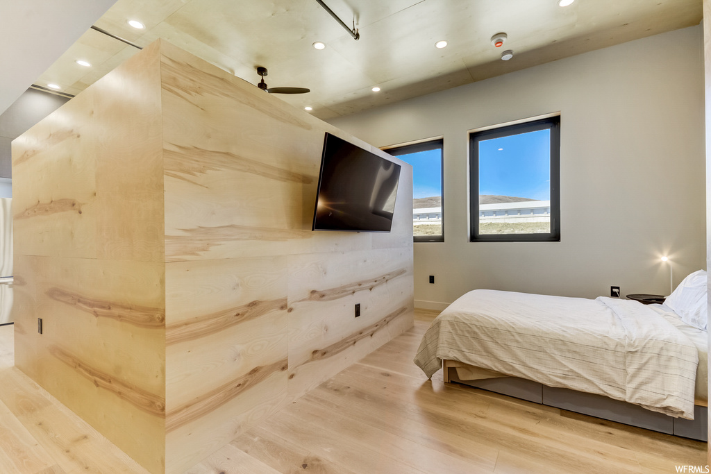 Hardwood floored bedroom featuring ceiling fan