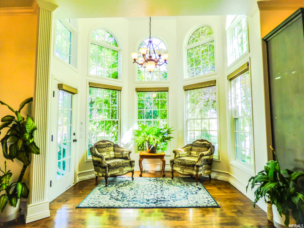 Sunroom / solarium with a notable chandelier and plenty of natural light