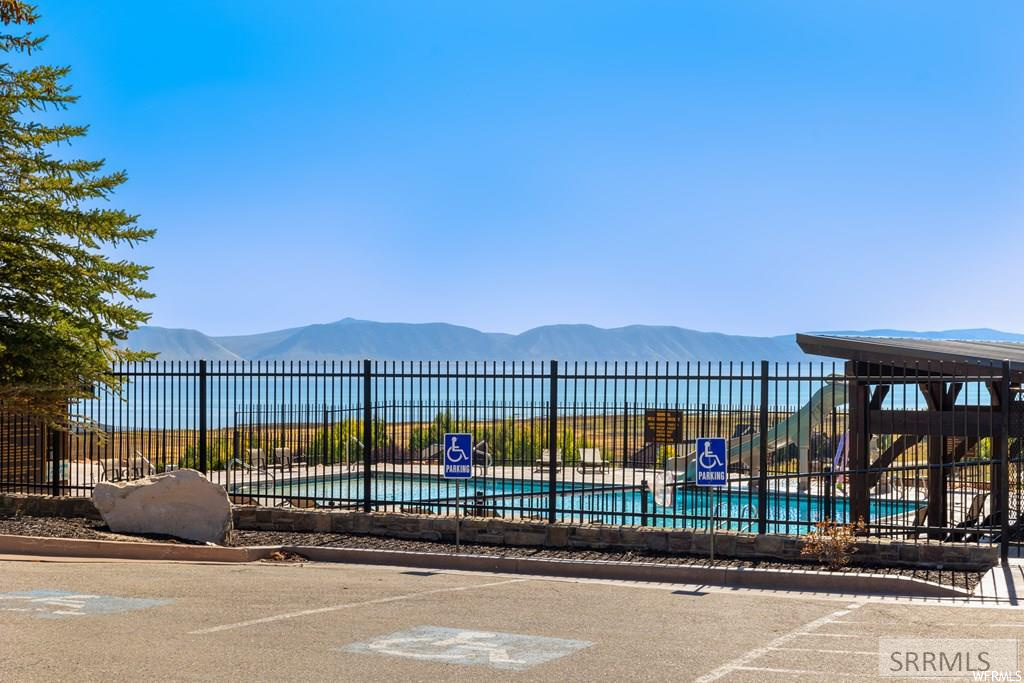 View of home's community featuring a swimming pool and a mountain view