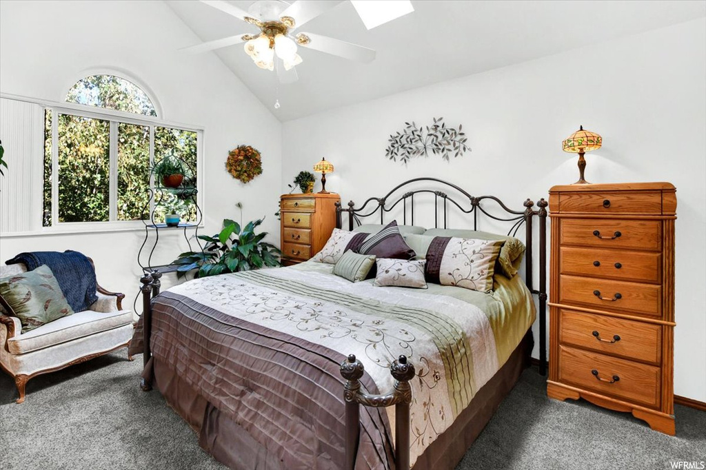 Carpeted bedroom featuring vaulted ceiling high and ceiling fan