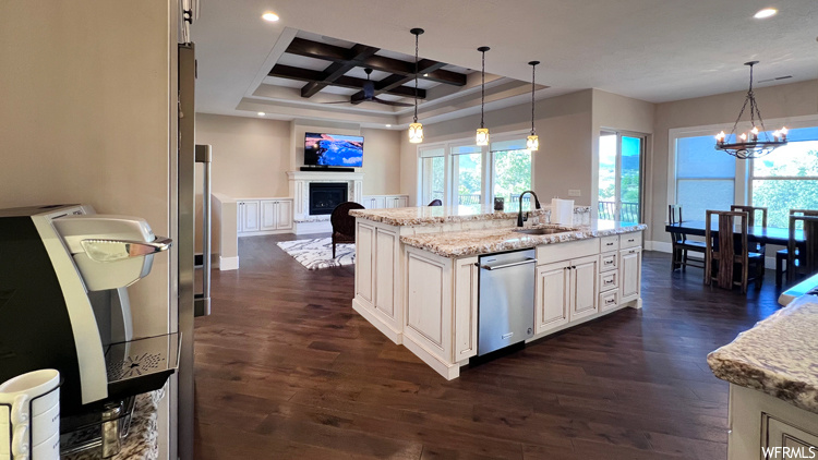 Kitchen with coffered ceiling, pendant lighting, dishwasher, beam ceiling, and dark hardwood floors