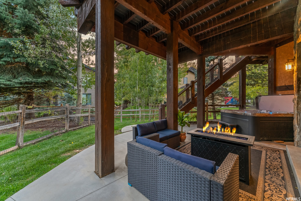 View of patio with an outdoor living space with a fire pit