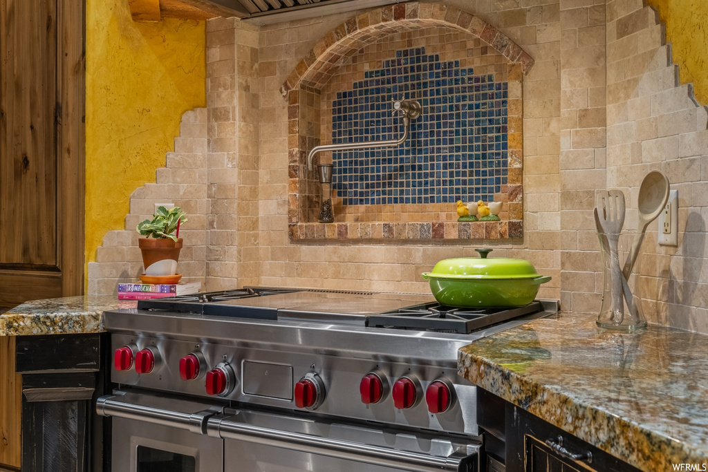Kitchen featuring stone countertops and double oven range