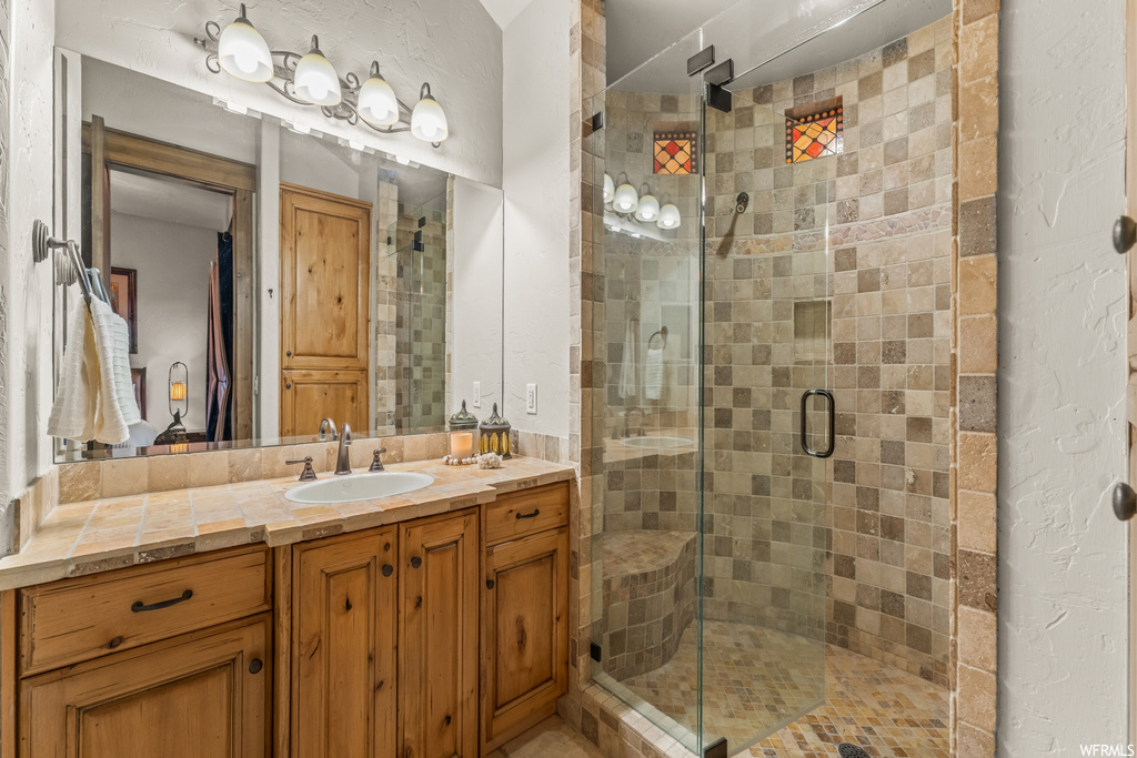 Bathroom with large vanity and an enclosed shower