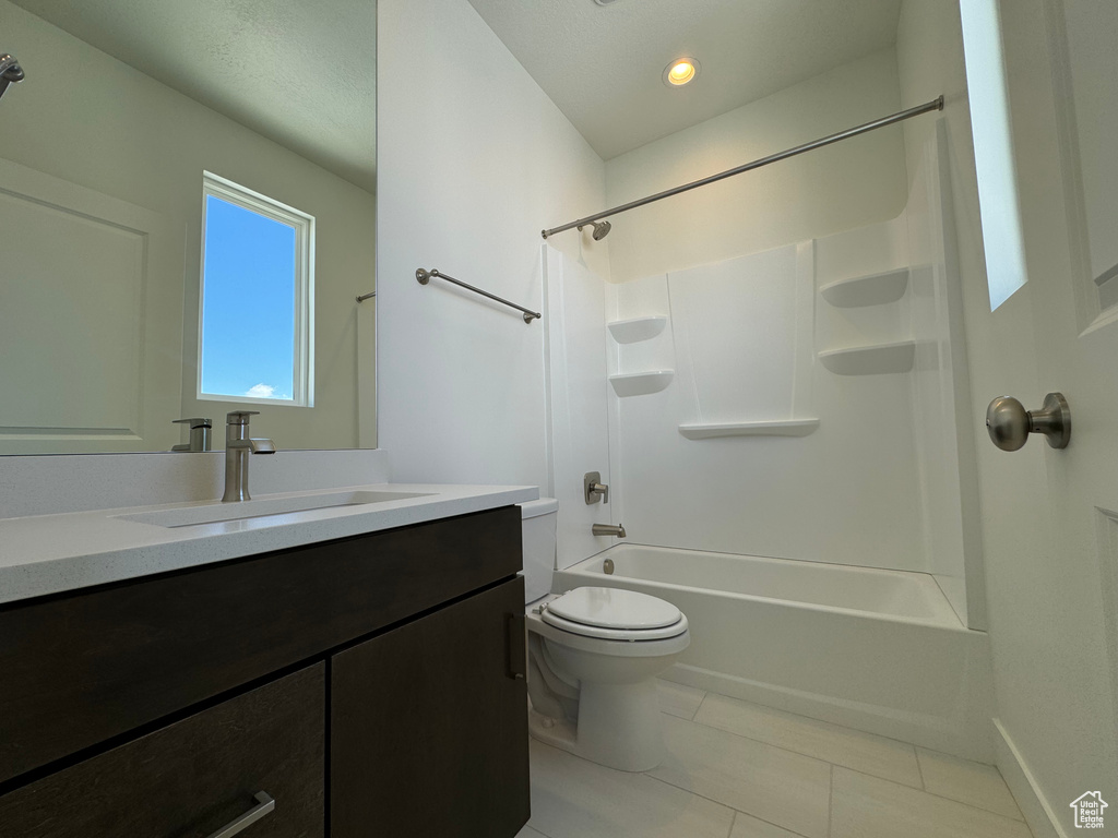 Full bathroom with toilet, tile flooring, shower / bathing tub combination, and vanity