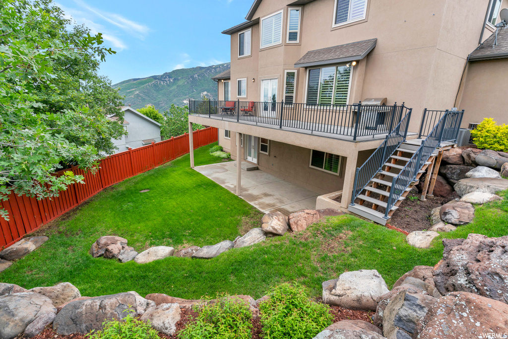 View of yard featuring a mountain view and a patio