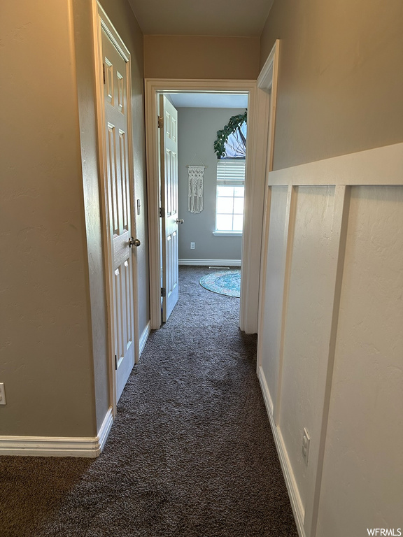 Hall with dark colored carpet