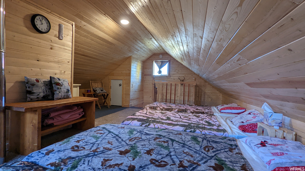 Carpeted bedroom with wood ceiling and lofted ceiling