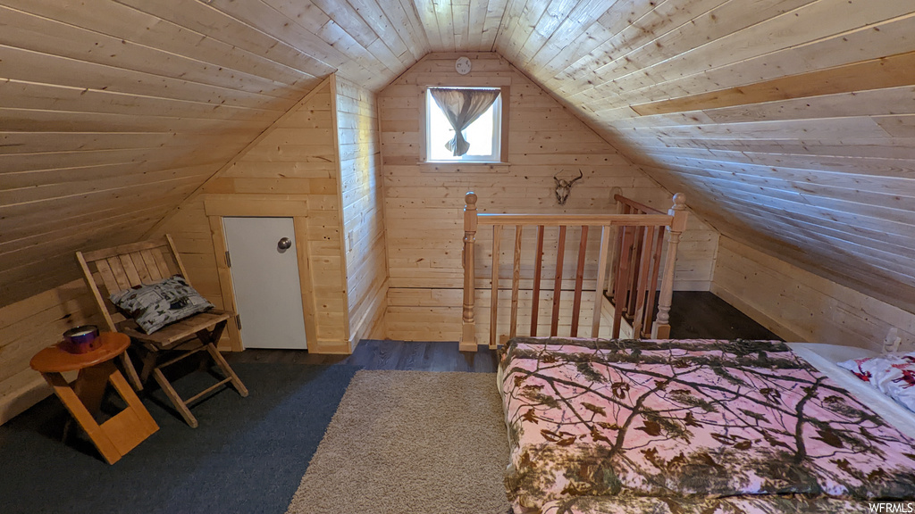 Unfurnished bedroom featuring lofted ceiling, wood ceiling, and dark hardwood floors